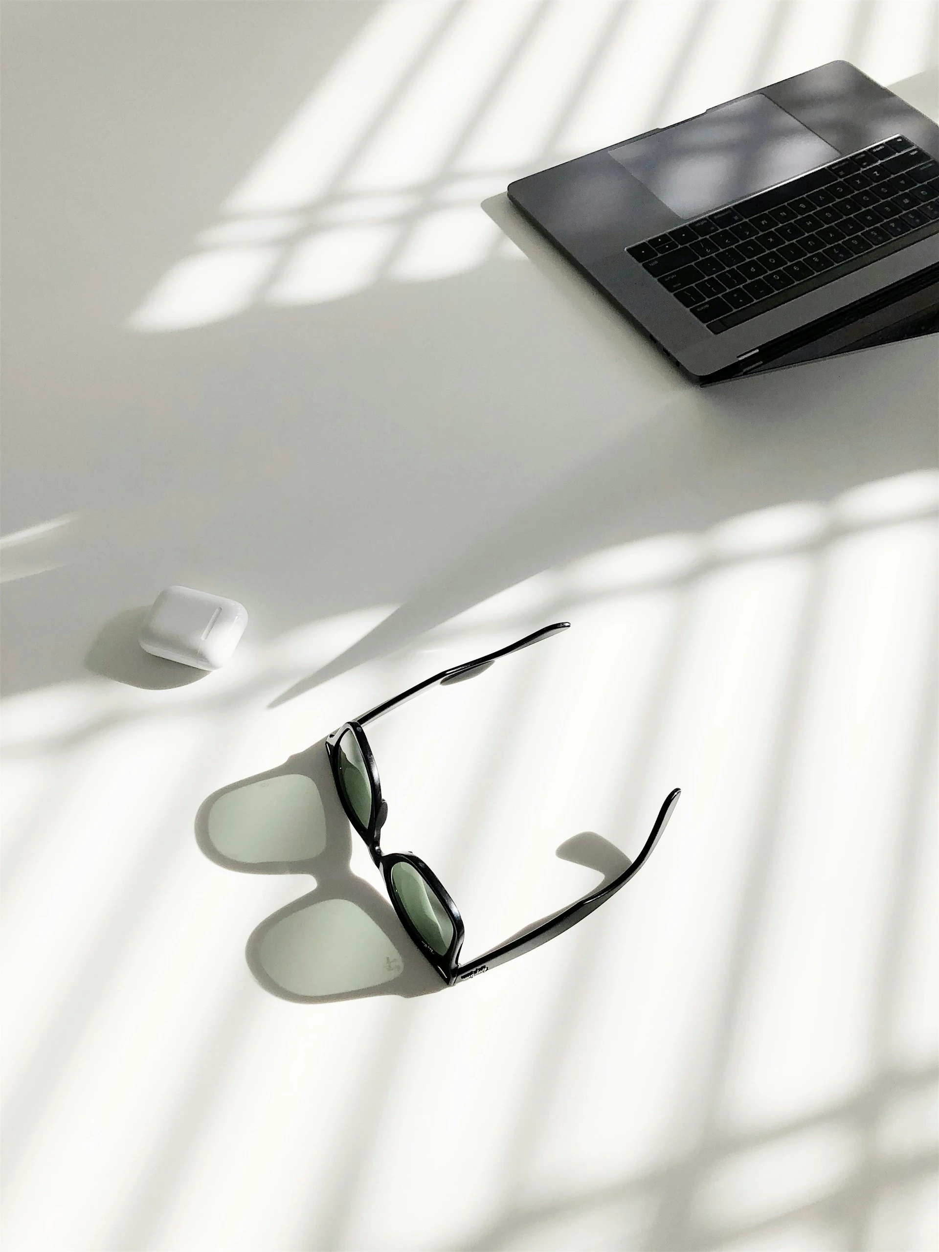 Sunglasses on floor with laptop Sunglasses on floor with laptop